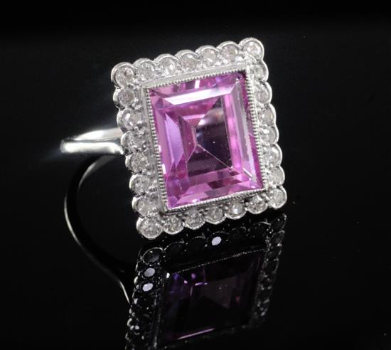 A mid 20th century 18ct white gold, pink sapphire and diamond cluster dress ring, size K.